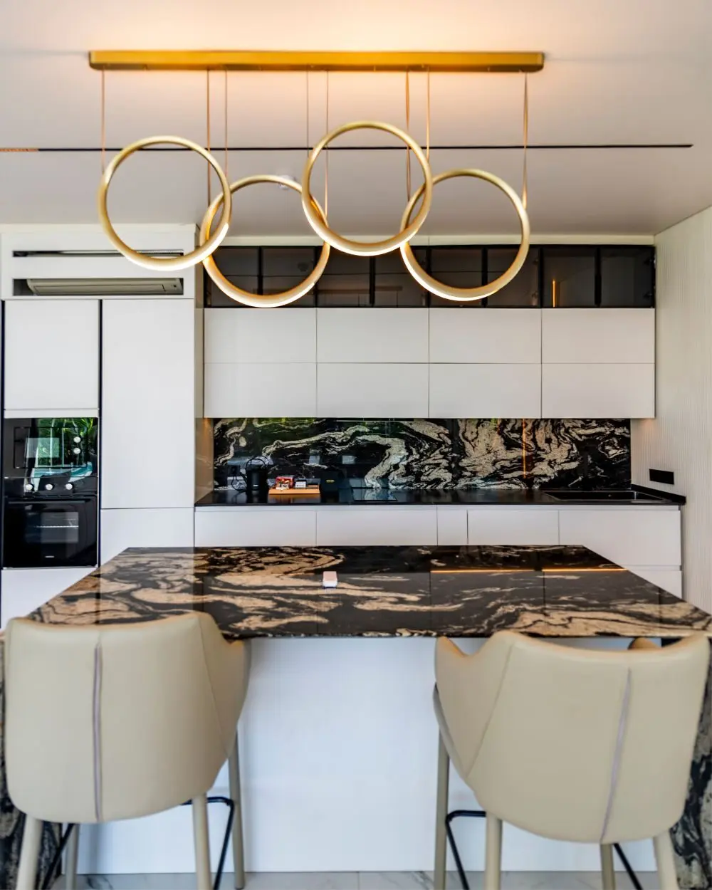 Island dapur dengan meja batu dan lampu gantung
