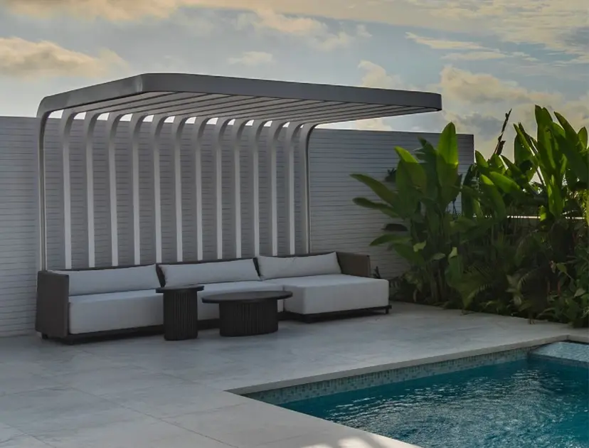 Pool terrace with a pergola lounge at sunset