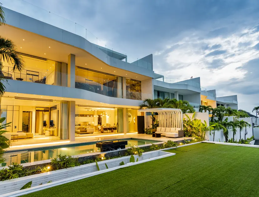 The Sky Stars villas at twilight, lit up above the lawn